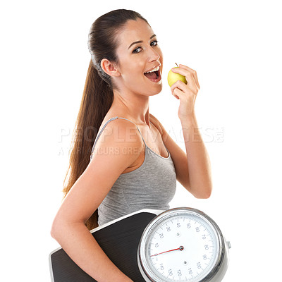 Buy stock photo Woman, scale and smile with apple in studio on white background for body weight, progress and fat loss with fitness. Portrait, happy and healthy with diet or nutrition for self care and health