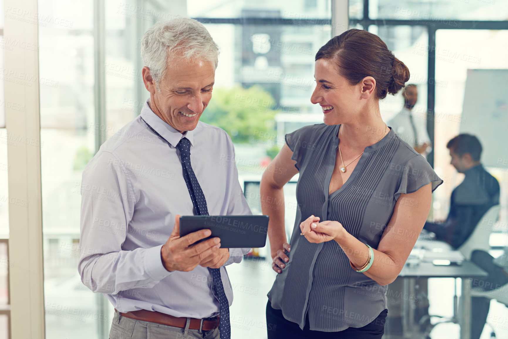 Buy stock photo Cropped shot of two businesspeople talking before their meeting