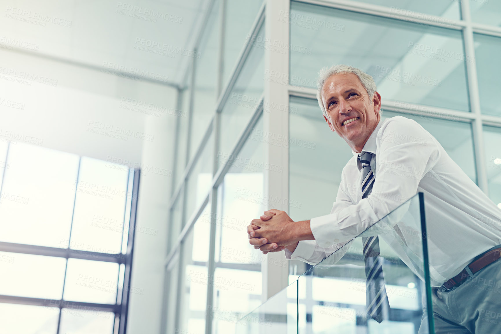 Buy stock photo Thinking, below and business with mature man in office, smile and confidence with career ambition. Finance, employee and accounting with pride, growth and development for company, joy and happiness