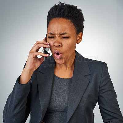 Buy stock photo Cropped shot of an angry businesswoman talking on a cellphone against a grey background