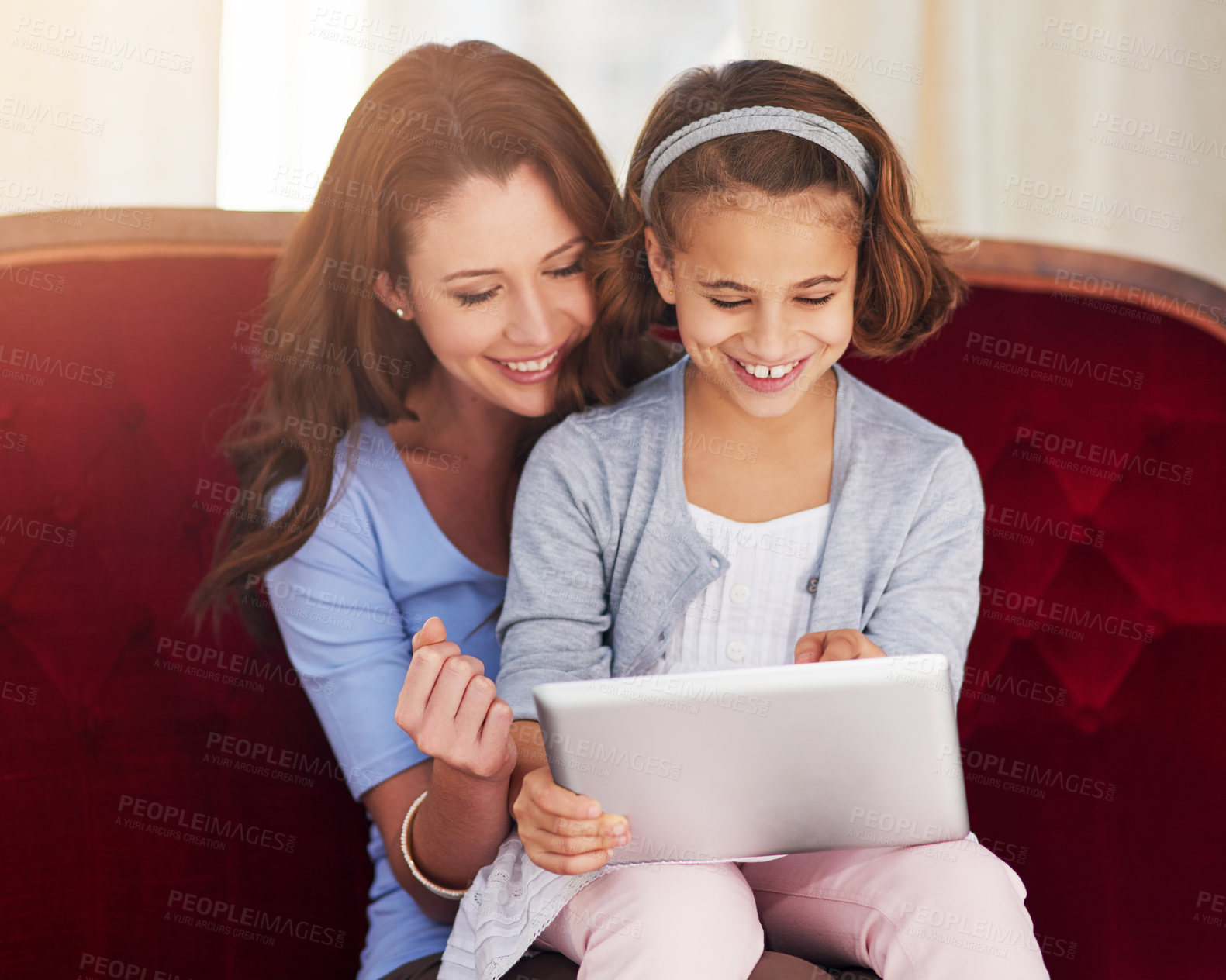 Buy stock photo Cropped shot of a mother and her daughter using a digital tablet