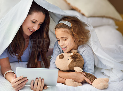 Buy stock photo Mother, daughter and tablet in house by bed with movies, video and games online holding teddy bear for mothers day bonding. Woman, child and technology for entertainment, internet and happiness