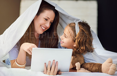 Buy stock photo Cropped shot of a mother and her daughter using a digital tablet