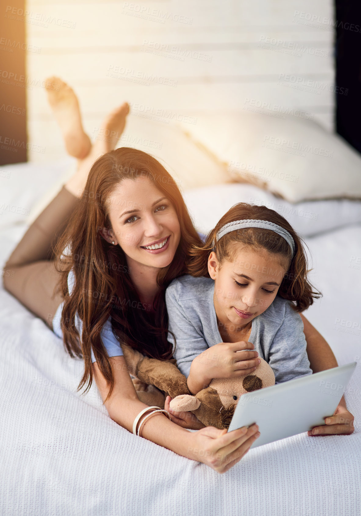 Buy stock photo Relax, tablet and mother with child in bedroom at home watch online video on app, internet or social media. Smile, love and mom with girl streaming movie, film or show on digital technology on bed.