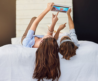 Buy stock photo Full length shot of a mother and her daughter using a digital tablet