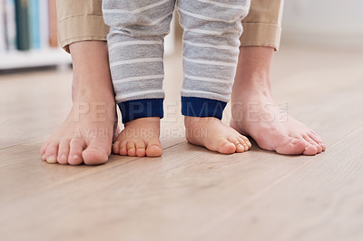 Buy stock photo Parent and baby feet, learning for growth, support and first steps to healthy development in closeup. Person, teaching and child to walk, balance and fine motor skills at home with love and hope