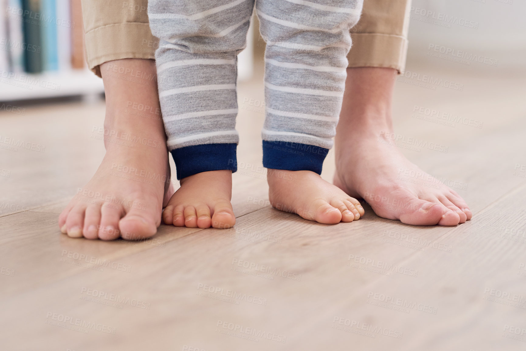 Buy stock photo Parent and baby feet, learning for growth, support and first steps to healthy development in closeup. Person, teaching and child to walk, balance and fine motor skills at home with love and hope