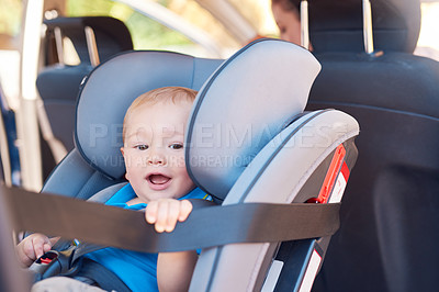 Buy stock photo Cropped shot of a mother sitting in a car with her baby boy in a car seat