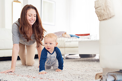 Buy stock photo Mom, baby and crawling for childcare with support, love and cute as toddler for growth and child development. Parent, kid and happy at home with playing for bonding, childhood memories and fun

