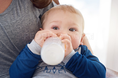 Buy stock photo Mother, child and feeding with milk, bottle and motor skills for development in childhood at home. Woman, infant and drinking for health, nutrition and support in nursery for growth or wellness