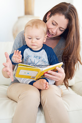 Buy stock photo Cropped shot of a mother reading a book to her baby boy at home