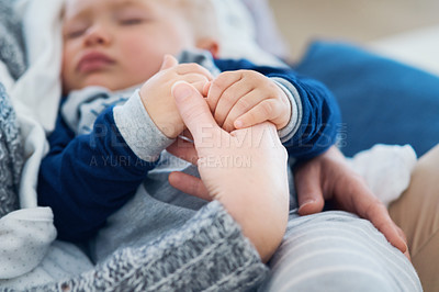 Buy stock photo Mommy, baby and sleeping for holding hands in home, security and support in bonding for wellness. Mother, toddler and care for maternity or nap on couch, child development and comfort for single mom