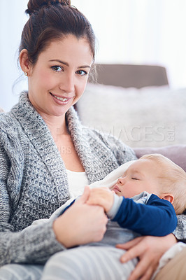 Buy stock photo Portrait of a mother holding her sleepy baby boy at home