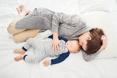 Buy stock photo Shot of a mother and her baby boy sleeping together at home