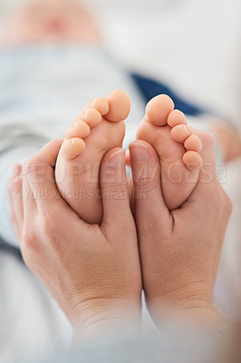 Buy stock photo Mommy, baby and toes for love in home, security and support in bonding for wellness or trust. Mother, toddler and care for maternity or relax on bed, child development and comfort for single mom