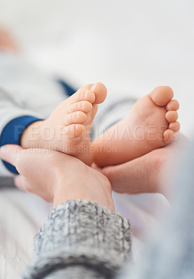 Buy stock photo Mommy, baby and feet for care in home, security and support in bonding for wellness or trust. Mother, toddler and love for maternity or relax on bed, child development and comfort for single mom