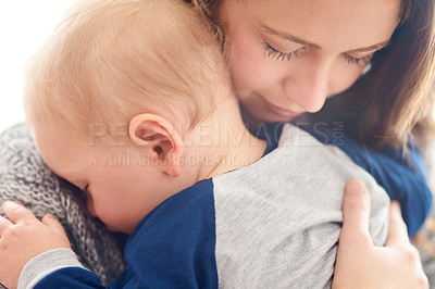 Buy stock photo Cropped shot of a mother holding her sleepy baby boy at home
