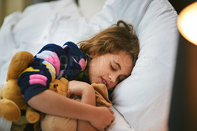 Buy stock photo Home, sleeping and girl with teddy bear in bed for growth, wellbeing and childhood development. Night, tired and rest of kid with stuffed animal in bedroom for health, peace and dreaming on pillow