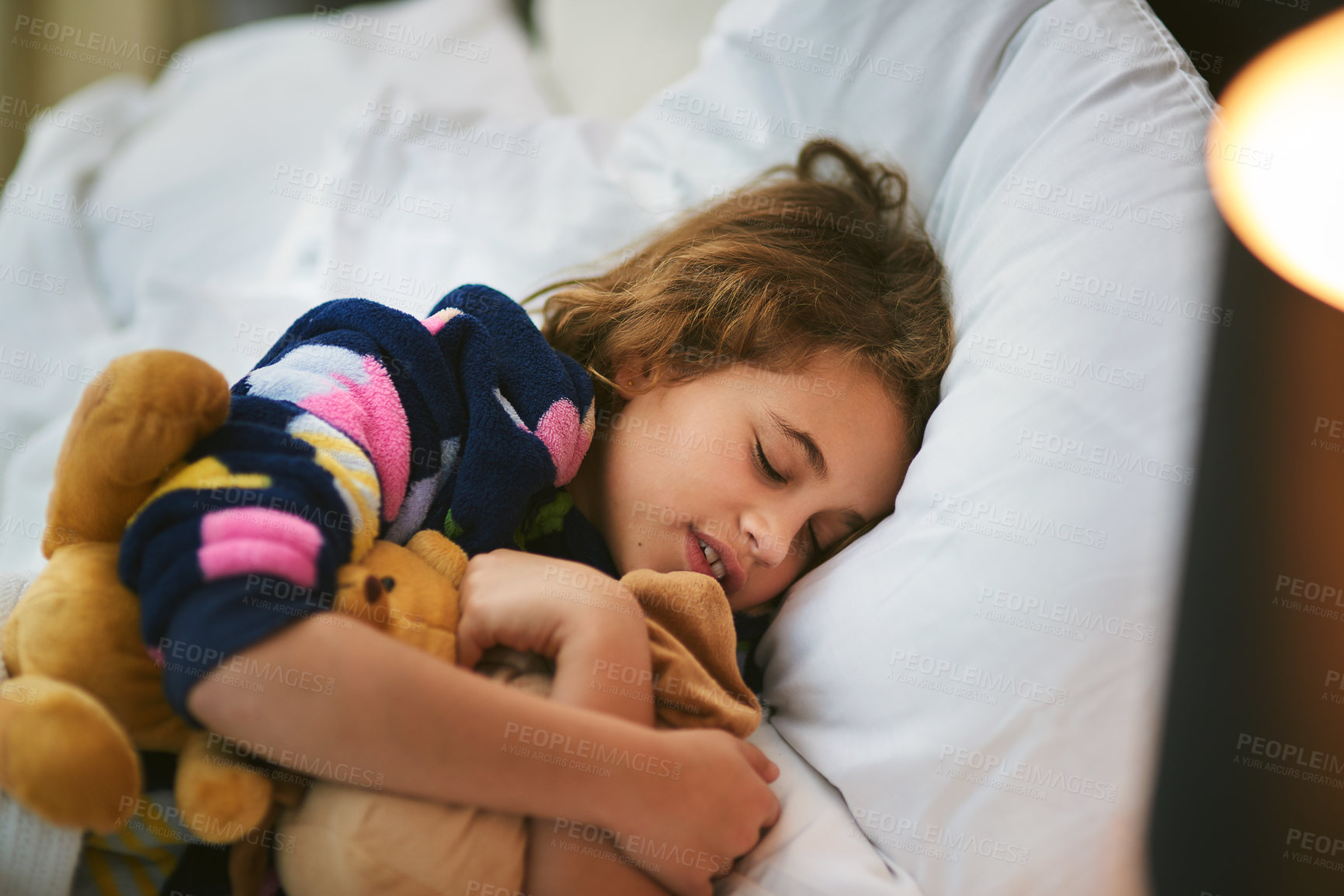 Buy stock photo Home, sleeping and girl with teddy bear in bed for growth, wellbeing and childhood development. Night, tired and rest of kid with stuffed animal in bedroom for health, peace and dreaming on pillow