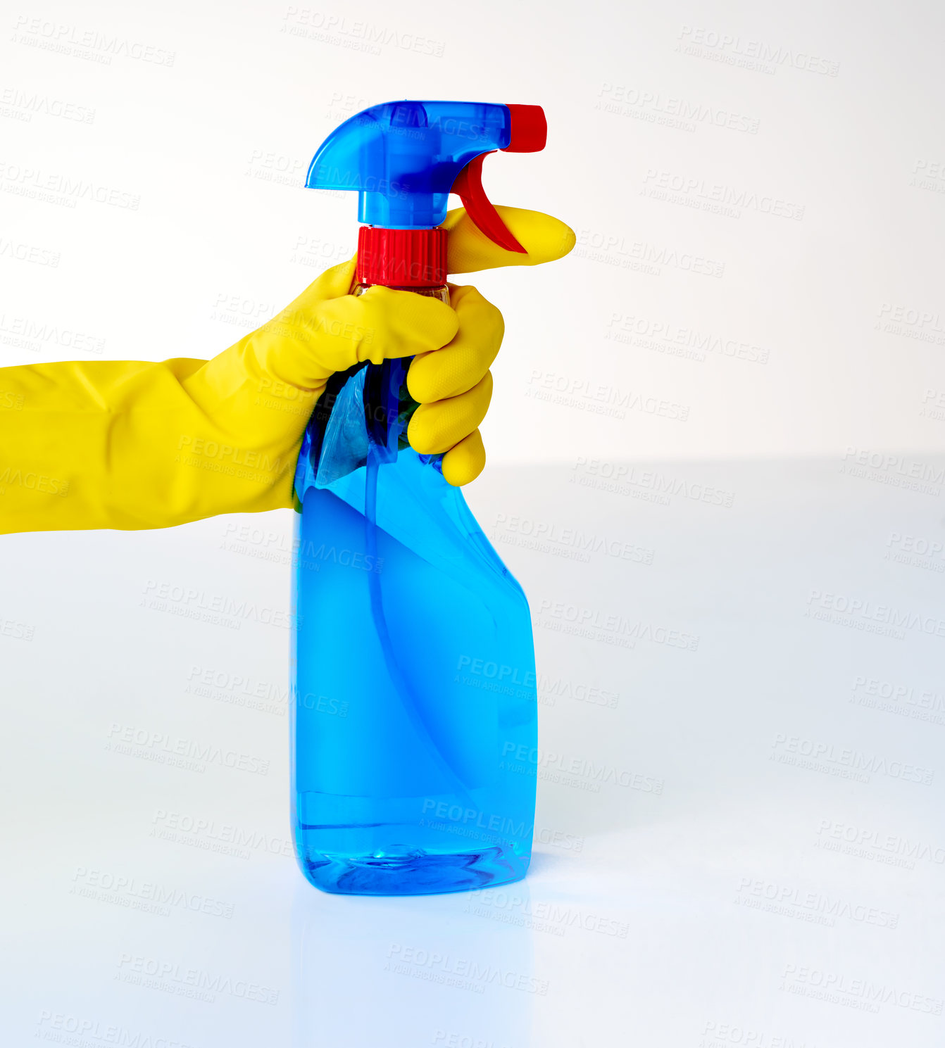 Buy stock photo Cropped shot of a person spraying from a bottle of detergent against a grey background