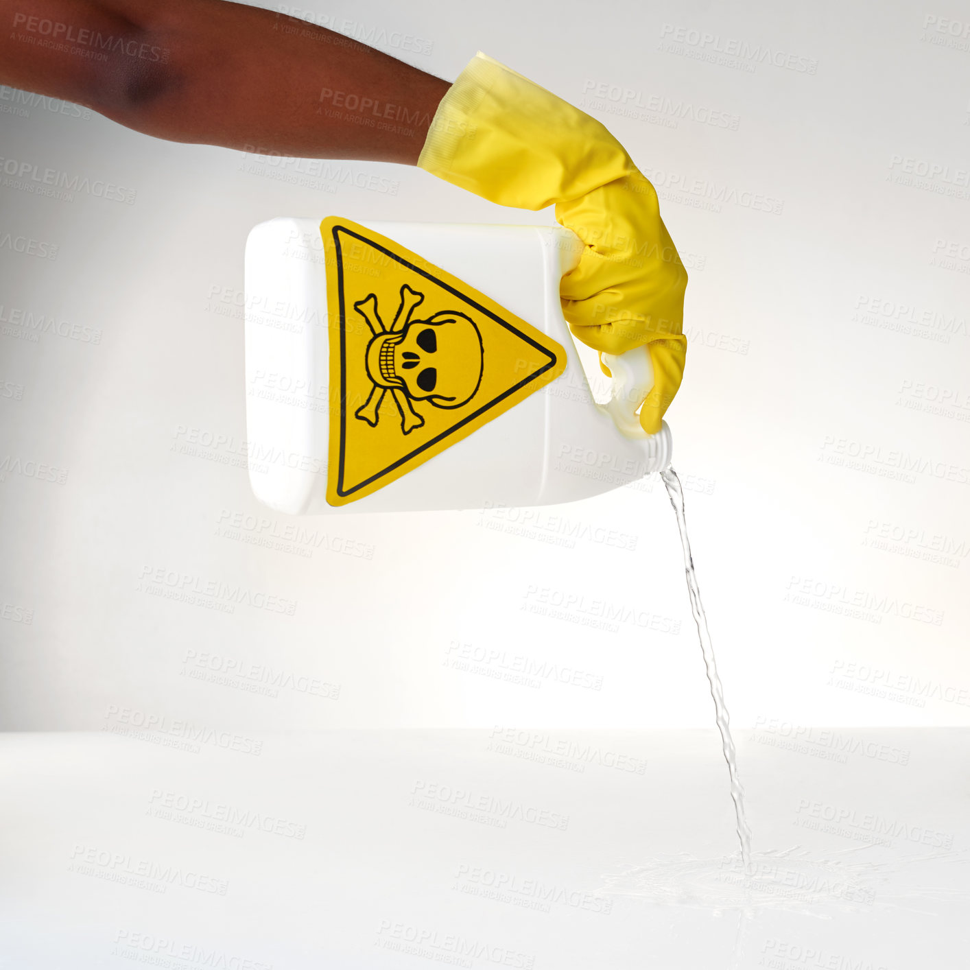 Buy stock photo Cropped shot of a person pouring out a bottle of toxic liquid against a grey background