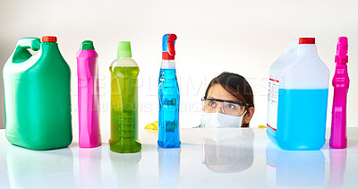 Buy stock photo Detergent bottles, products and woman with mask or glasses for protection, safety and cleaning at home. Housekeeping, cleaner or female person with soap, liquid container or spray on table for dust