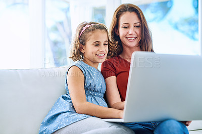 Buy stock photo Cropped shot of a mother and daughter using a laptop together at home