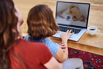 Buy stock photo Cropped shot of a mother and daughter using a laptop together at home