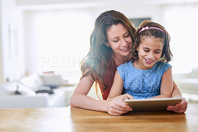 Buy stock photo Cropped shot of mother and daughter using a digital tablet together at home