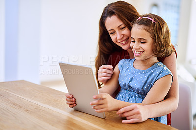 Buy stock photo Mother, girl and tablet for bonding at table, online play and remote learning or education in home. Daughter, mama and website for cartoon or games for development, love and support in childhood