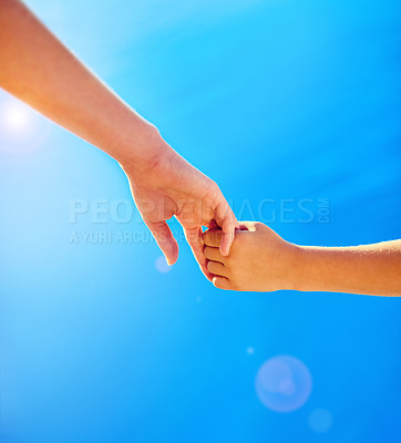 Buy stock photo Closeup shot of an adult and child holding hands together outside