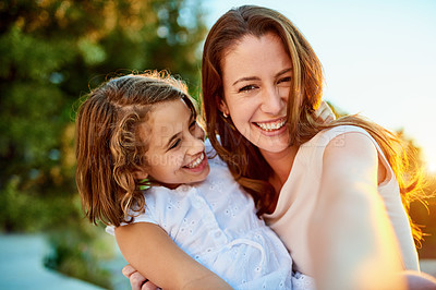 Buy stock photo Portrait of a mother and daughter taking a selfie together outside