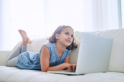 Buy stock photo Shot of a young girl using a laptop at home