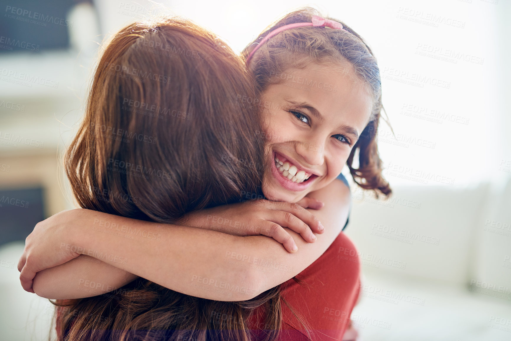 Buy stock photo Portrait of a young girl hugging her mother at home