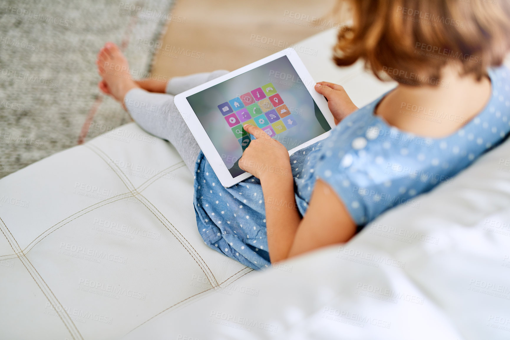 Buy stock photo Cropped shot of a young girl using a digital tablet at home