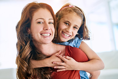 Buy stock photo Portrait of a mother giving her daughter a piggyback ride at home