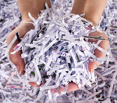 Buy stock photo Studio shot of a woman's hands holding a pile of shredded paper