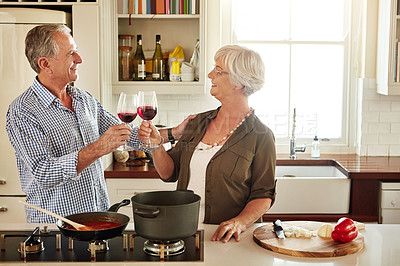 Buy stock photo Cheers, happy or old couple cooking food for a healthy vegan diet together with love in retirement at home. Smile, toast or senior woman drinking wine in kitchen to celebrate with husband at dinner 
