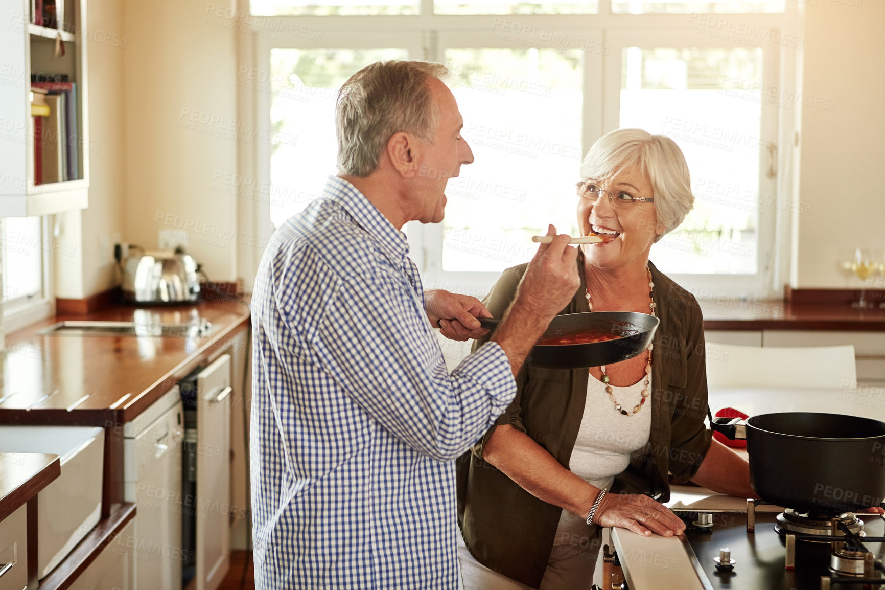 Buy stock photo Taste, happy or old couple kitchen cooking with healthy food for lunch or dinner together at home in retirement. Senior woman tasting or smiling with mature husband in meal preparation in Australia