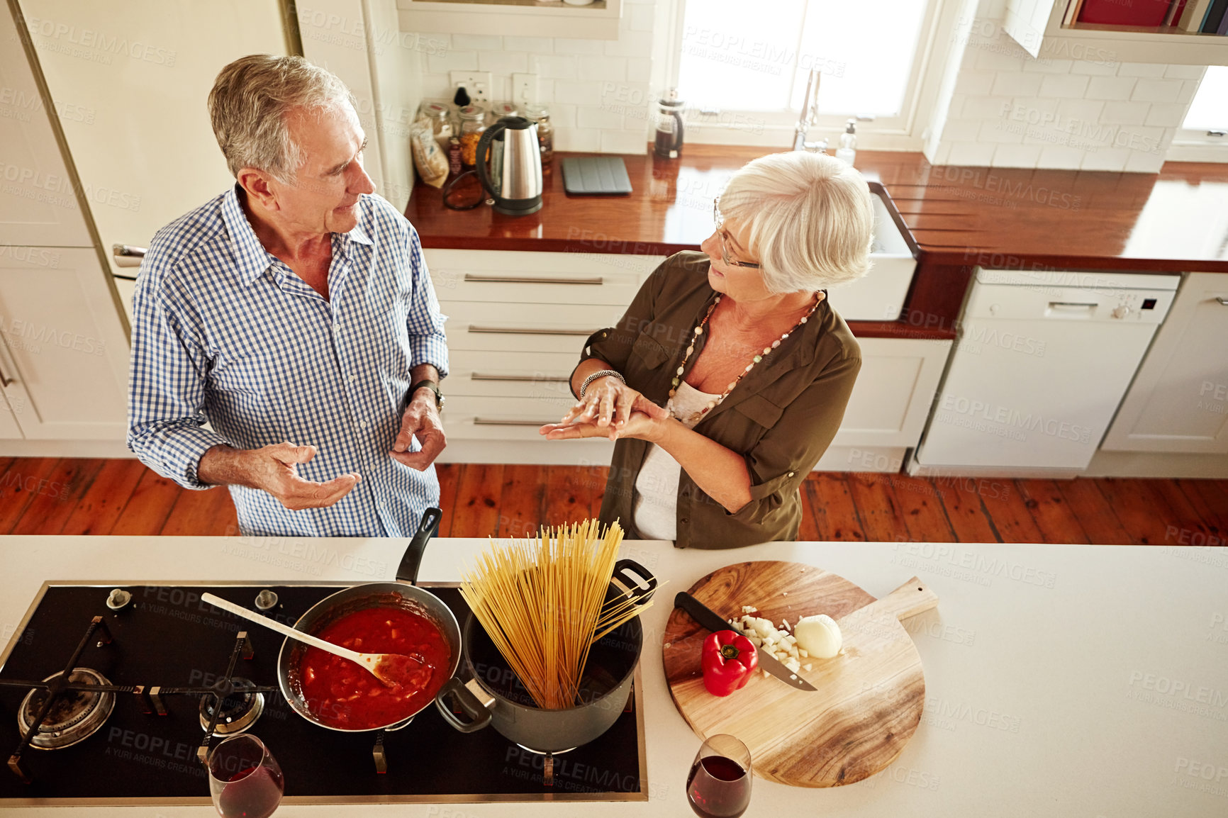 Buy stock photo Top view, speaking or old couple in kitchen cooking with healthy vegetables for lunch meal or dinner together. Senior woman helping or talking to mature husband in food meal preparation in retirement