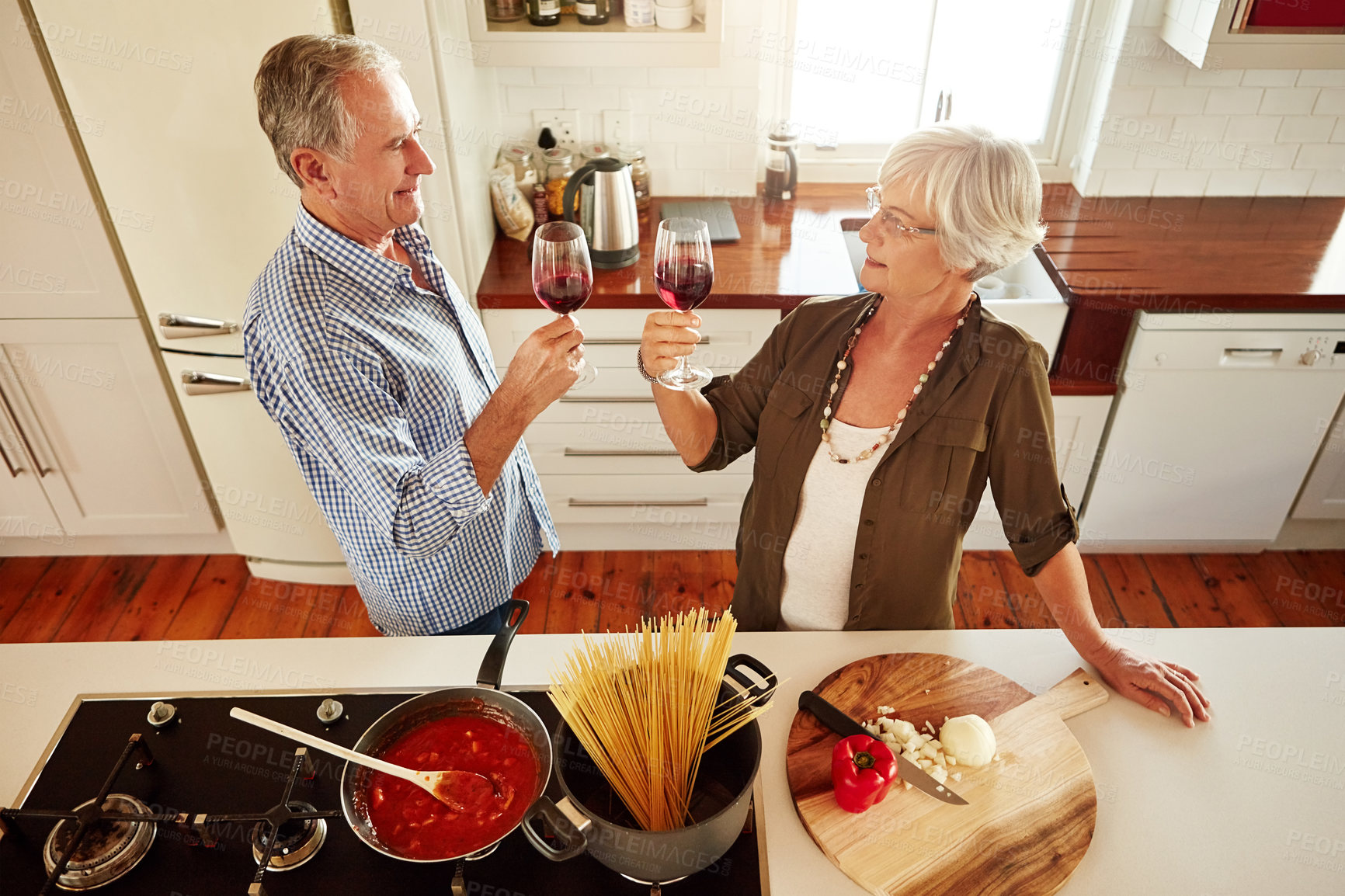 Buy stock photo Toast, wine or old couple cooking food for healthy vegan diet together in retirement at home. Above, cheers or romantic senior woman drinking or toasting in kitchen with a happy husband at dinner
