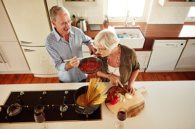 Buy stock photo Top view, taste or old couple kitchen cooking with healthy food for lunch or dinner together at home. Love, help or senior woman tasting or eating with mature man in meal preparation in retirement