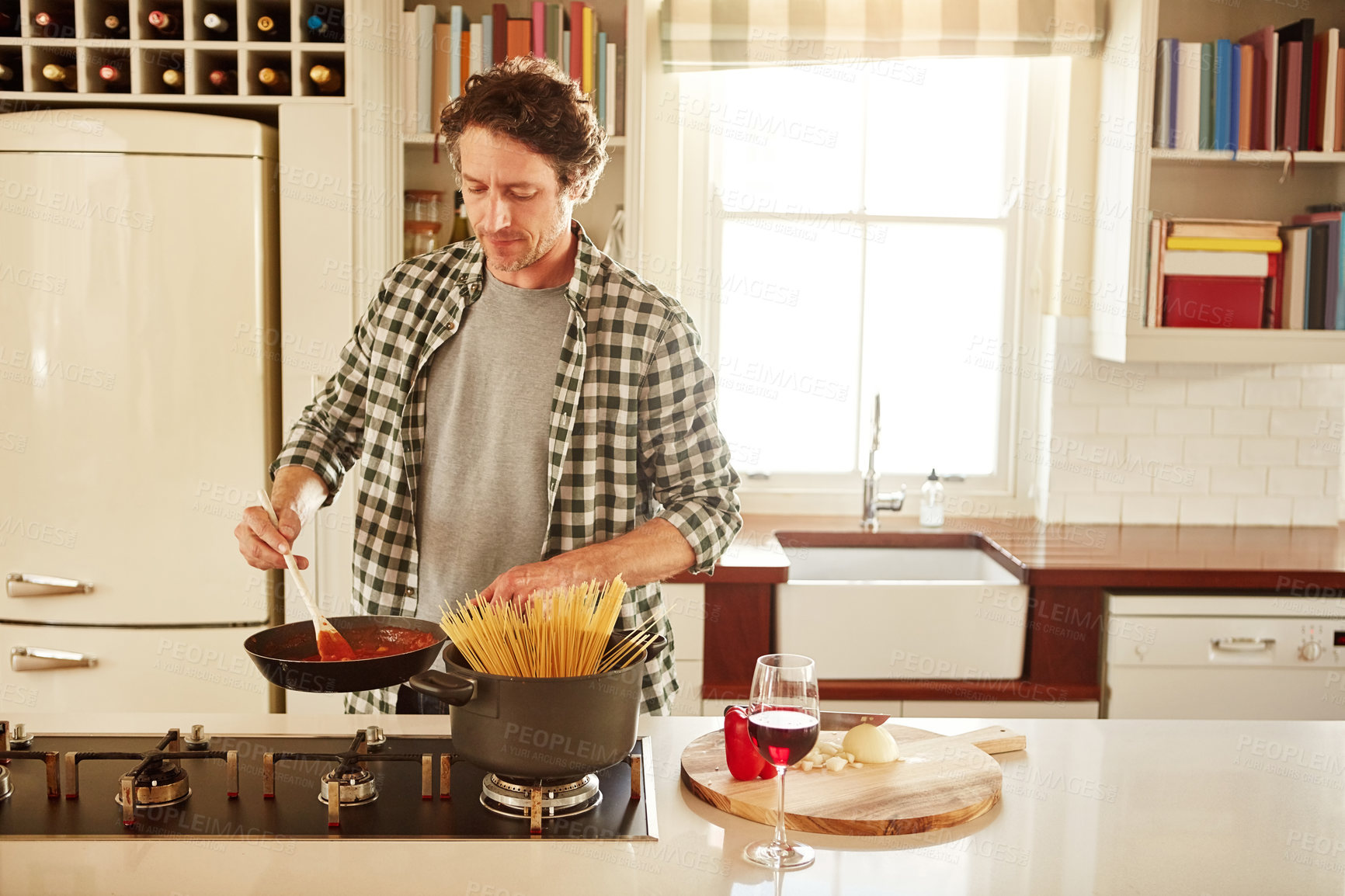 Buy stock photo Food, cooking or mature man in kitchen with healthy vegan diet for nutrition or wellness at home in Australia. Wine glass, spaghetti or male person in house kitchen in preparation for dinner meal 
