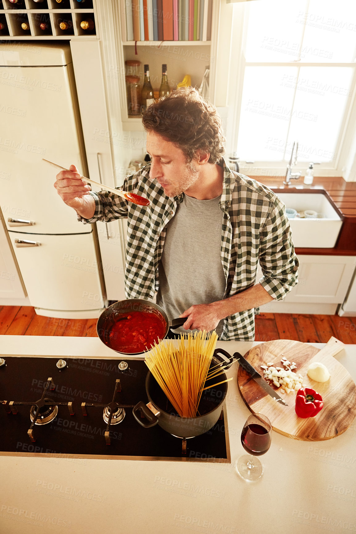 Buy stock photo Food, cooking or man tasting in kitchen with healthy vegan diet for nutrition or vegetables at home in Italy. Spaghetti sauce taste, above or person in house kitchen in preparation for dinner meal