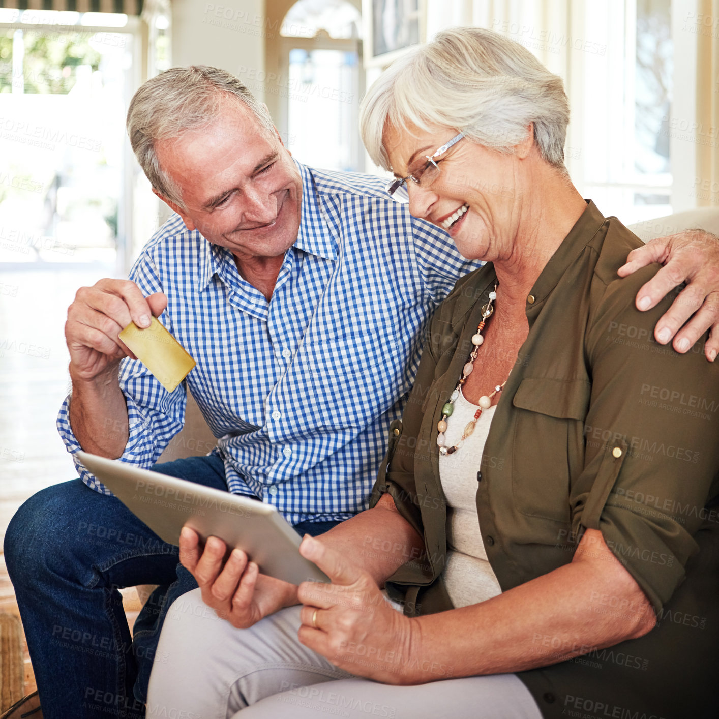 Buy stock photo Cropped shot of a senior couple shopping online on their tablet