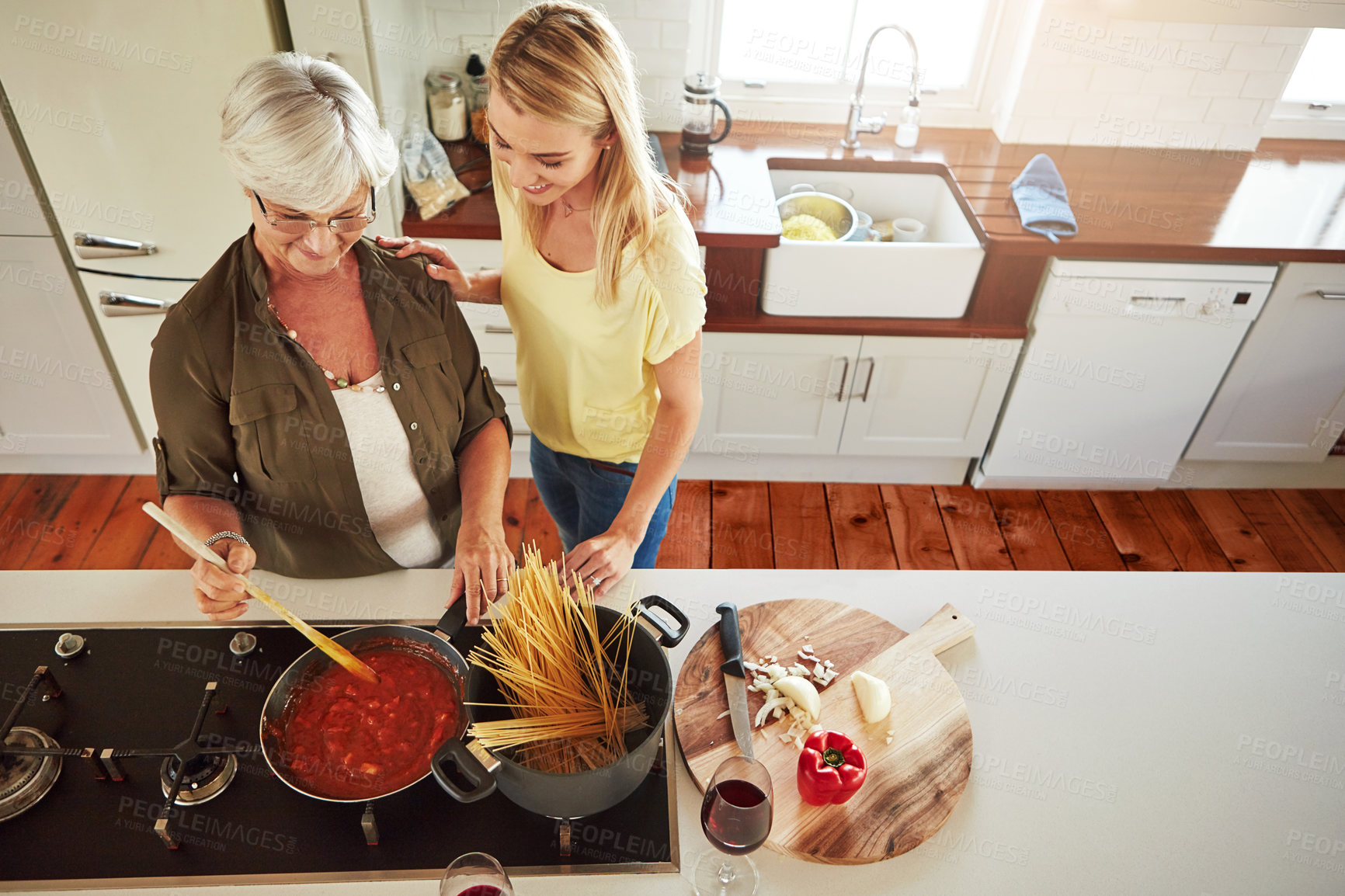 Buy stock photo Teaching, woman or mother cooking food for a healthy vegan diet together with love in family home. Girl, above or adult child learning or helping senior mom in house kitchen for lunch meal or dinner 