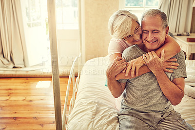 Buy stock photo Cropped shot of a senior couple embracing in their bedroom