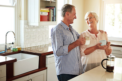 Buy stock photo Happy, coffee or old couple laughing in kitchen at home bonding or enjoying quality morning time together. Funny, affection or mature man talking, relaxing or drinking tea espresso with woman at home