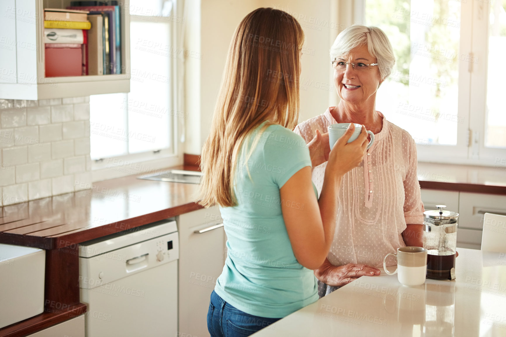 Buy stock photo Mother, coffee or woman chatting in kitchen in family home bonding or enjoying quality time together. Girl speaking, retirement or adult child talking, relaxing or drinking tea with senior parent