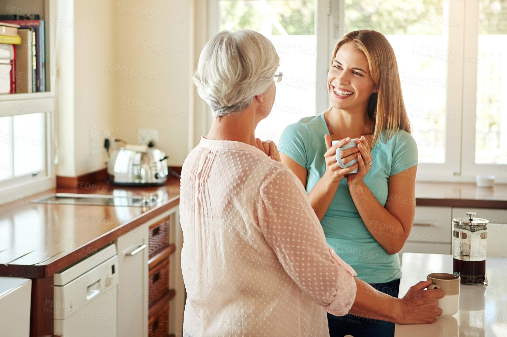Buy stock photo Mother, coffee or happy woman laughing in kitchen in family home bonding or enjoying quality time together. Speaking, retirement or funny girl talking, relaxing or drinking tea with senior parent 